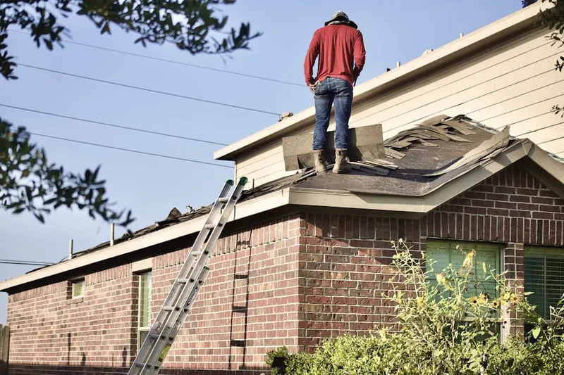 Professional roofer working on a residential roof in Waynewoods